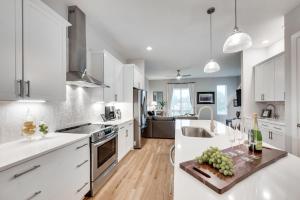 a kitchen with white cabinets and a counter top at Noble Nash - 8 Mins to Grand Ole Opry in Nashville