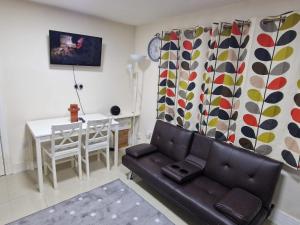 a living room with a couch and a table at Deluxe 1-Bed Apartment in Greenford in Greenford