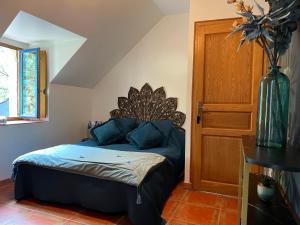 een slaapkamer met een bed en een vaas op een tafel bij Le Clos Saint Fiacre in Carentoir