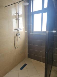 a bathroom with a shower with a window at Luxury Gest house in Addis Ababa