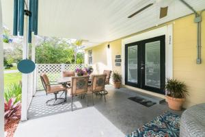 a patio with a table and chairs on a house at Fun 5* Hot Tub/Beaches getaway Near MAYO in Jacksonville