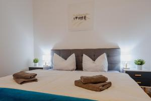 a bedroom with a large bed with two pillows at Erholsamen Sundowner auf der Terrasse erleben! #7uAbendsonne in Dranske