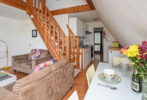 a kitchen and a living room with a staircase at Chalet Thirtysix in Deal