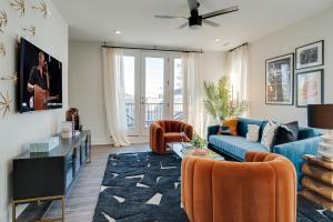 a living room with a blue couch and orange chairs at Nashville - 5623 Lenox Ave in Nashville