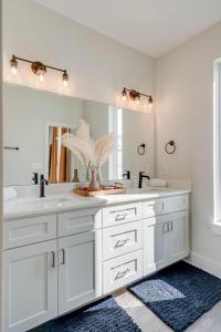 a white bathroom with two sinks and a mirror at Nashville - 5623 Lenox Ave in Nashville