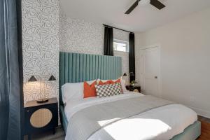 a bedroom with a bed with a green headboard at Nashville - 5623 Lenox Ave in Nashville