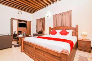 a bedroom with a large bed with red pillows at Naket royal guest house in Accra