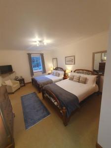 a large bedroom with two beds and a television at Appin Bay View in Appin