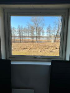 a window in a room with a view of a field at Atterfallshus1 in Nyköping