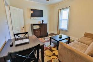 a living room with a couch and a table at Nader's Motel & Suites in Ludington