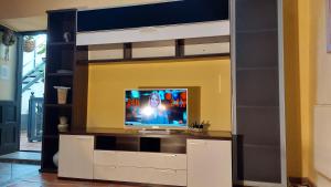 a room with a bed with a tv and a tv stand at Apartamentos-Monasterio-de-San-Antonio-Guenstiges-Apartment-zur-Strasse in Icod de los Vinos