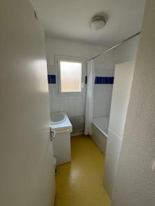 a bathroom with a sink and a toilet and a window at Villa de 6 pers, 500m plage. in Soulac-sur-Mer