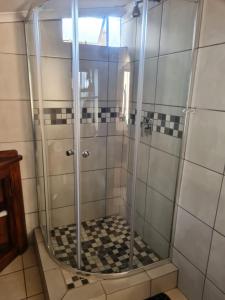 a shower with a glass door in a bathroom at Home Sweet Home in Polokwane