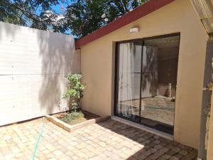 a house with a sliding glass door to a patio at Home Sweet Home in Polokwane