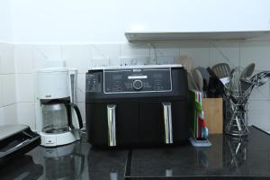 a microwave sitting on a counter in a kitchen at Beautiful 4-Bed House in Erith in Erith