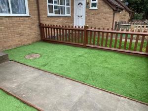 a backyard with a fence and green grass at Beautiful 4-Bed House in Erith in Erith