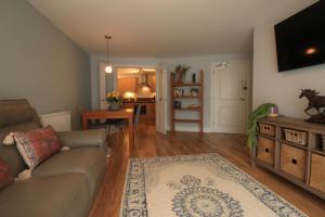 a living room with a couch and a dining room at Streamside Apartments in Yeovil