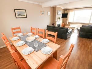 a dining room with a table and chairs at Murmur y Mor in Goodwick