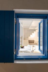 a blue window with a view of a room at Blue Paros House Paroikia Center close to port in Kampos Paros