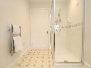 a bathroom with a shower with a glass shower stall at Little Tregarrick in Helston