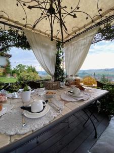 a table with plates and utensils on top at B&B Casa Margot in Neive