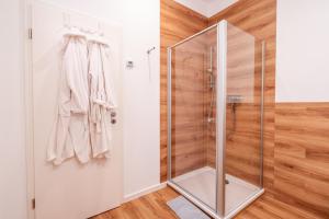 a bathroom with a shower with a glass door at App 8u Heimatliebe in Dranske
