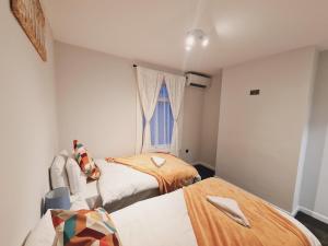 a bedroom with two beds and a window at Belvedere House 2 bedroom Greater London in Belvedere