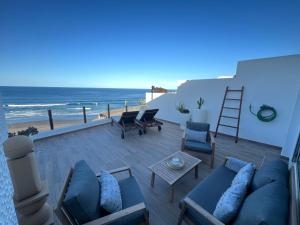a patio with a view of the beach at Playa del Hombre Deluxe Luxury Apartments in Playa del Hombre