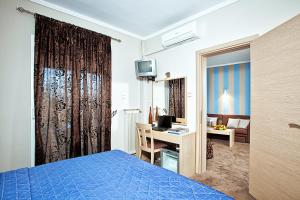 A bed or beds in a room at Anastassiou Hotel - Bike and motorcycle friendly hotel