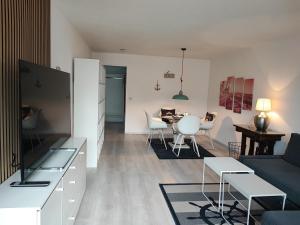 a living room with a couch and a table at FeWo Segelwind in Bodman-Ludwigshafen
