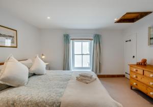 a bedroom with a large bed and a window at The Old Sweet Shop in Wells next the Sea