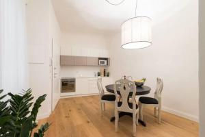 a kitchen with a dining room table and chairs at Tornabuoni TOT - luxury apartments in Florence