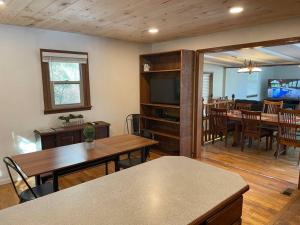 a living room with tables and a dining room at Hocking Hills Cottage with beautiful pond in Logan