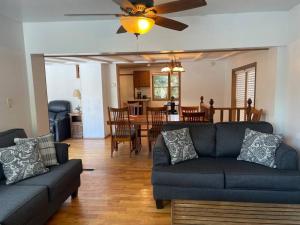 a living room with a couch and a dining room at Hocking Hills Cottage with beautiful pond in Logan