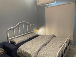 a bedroom with a bed and a air conditioner at Eco Room in Jeddah