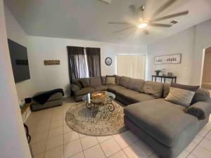 a living room with a couch and a table at Lake Havasu 4b/2b pool/spa/view in Lake Havasu City