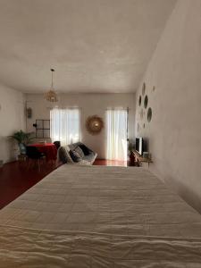a bedroom with a large bed in a room at Casa Roma in Taxco de Alarcón
