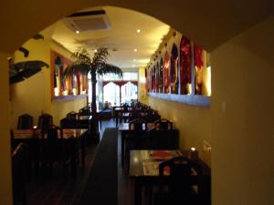ein Restaurant mit einem Speisesaal mit Tischen und Stühlen in der Unterkunft SIMLA INDIAAS RESTAURANT VOOR KAMER in Sittard