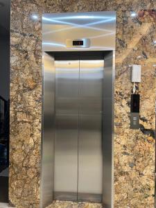 a elevator in a building with a stone wall at 54 homestay Van Mieu in Hanoi