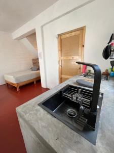 a kitchen with a sink and a counter top at Casa Roma in Taxco de Alarcón