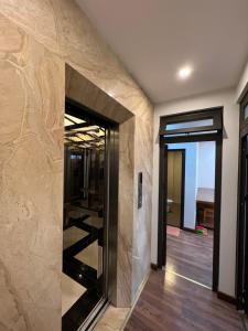a hallway with a stone wall with a doorway at 54 homestay Van Mieu in Hanoi