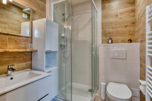 a bathroom with a shower and a toilet and a sink at App Le Galet 5min du port in Fécamp