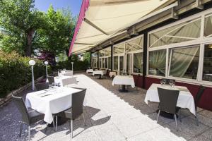 a restaurant with tables and chairs in front of a building at Residence Bertolini in Padova