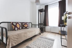 a bedroom with a bed and a window and a rug at Jewish Quarter Hideaway with terrace and parking - 507 in Budapest