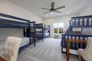 a room with four bunk beds and a table and a ceiling fan at Majestic Manor-Private Hundred Acre Yard-Pool/Spa in Lebanon +107 photos