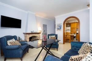 salon z niebieskimi krzesłami i kominkiem w obiekcie Apartamento Renovado "Hogar Las Vistas" w mieście Los Realejos
