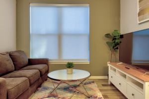 a living room with a couch and a table at Kasa Forest Park St Louis in Maryland Heights