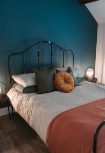 a bedroom with a bed with a blue wall at Apartment at 68 in Saintfield