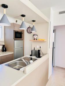 a kitchen with a sink and a counter top at Chez Garance à la Bouillabaisse in Saint-Tropez