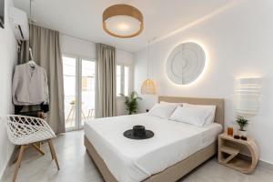 a bedroom with a bed with a hat on it at Golden Bird's in Naxos Chora